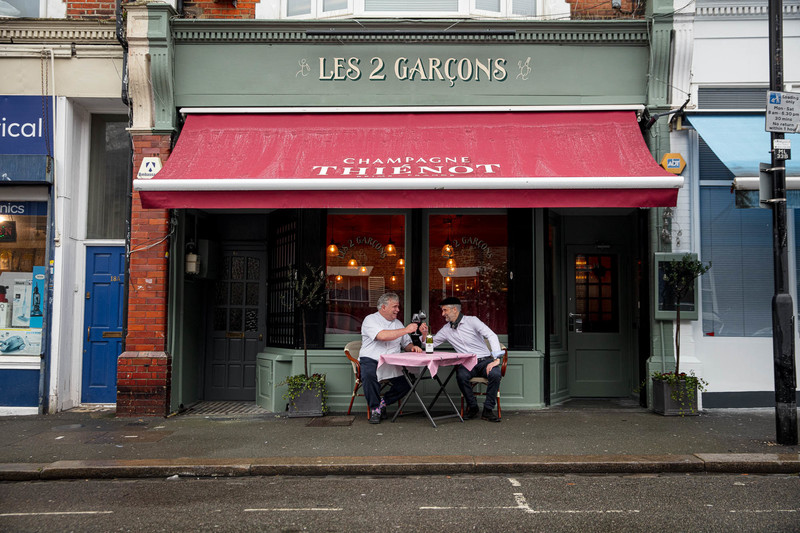 Robert Reid and Jean-Christophe Slowik sit outside their restaurant Les 2 Garçons in Crouch End. Regional winner of The Good Food Guide Best Local Restaurant Award 2023, London, England